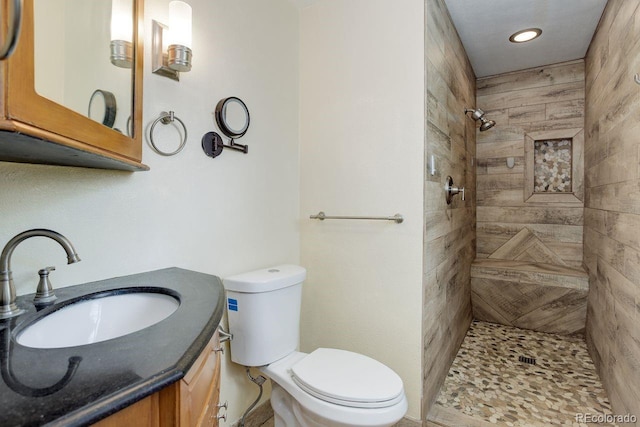 8795 Rudd Rd, Evergreen, CO 80439 - full bathroom featuring a tile shower, toilet, vanity, and recessed lighting