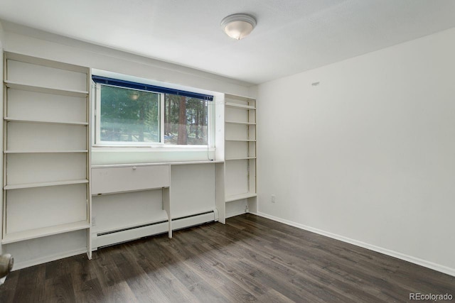 8795 Rudd Rd, Evergreen, CO 80439 - unfurnished room with baseboard heating, dark wood-type flooring, and baseboards