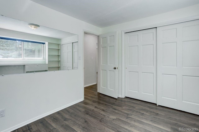 8795 Rudd Rd, Evergreen, CO 80439 - unfurnished bedroom with dark wood finished floors and baseboards