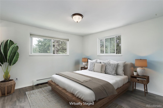 8795 Rudd Rd, Evergreen, CO 80439 - bedroom with a baseboard heating unit, multiple windows, wood finished floors, and baseboards
