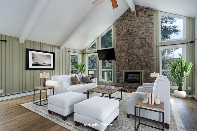 8795 Rudd Rd, Evergreen, CO 80439 - living room with wood finished floors, healthy amount of natural light, a ceiling fan, and a fireplace