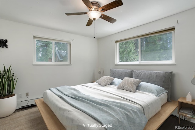 8795 Rudd Rd, Evergreen, CO 80439 - bedroom with wood finished floors and a baseboard radiator