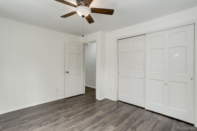 8795 Rudd Rd, Evergreen, CO 80439 - unfurnished bedroom with dark wood-style floors, baseboards, a closet, and a ceiling fan