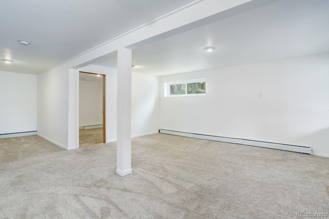 8795 Rudd Rd, Evergreen, CO 80439 - basement featuring a baseboard heating unit, carpet, and baseboards