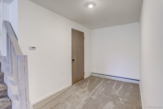 8795 Rudd Rd, Evergreen, CO 80439 - unfurnished room featuring a baseboard heating unit, stairs, carpet floors, and baseboards