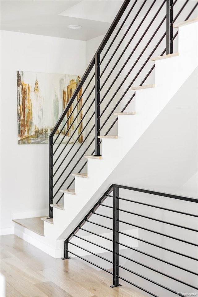 stairs with hardwood / wood-style floors