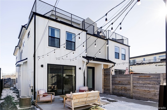 rear view of house with central AC and a patio