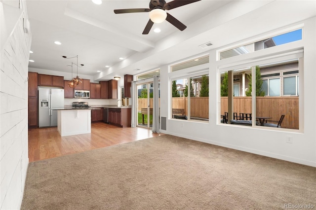 3692 Celestial Ave, Castle Rock, CO 80109 - kitchen with appliances with stainless steel finishes, light colored carpet, open floor plan, a sink, and recessed lighting