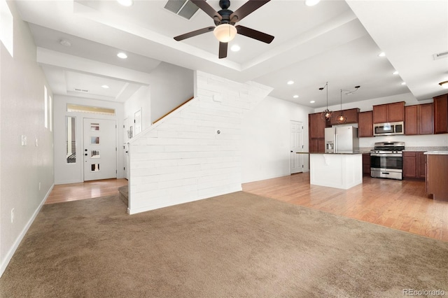 3692 Celestial Ave, Castle Rock, CO 80109 - unfurnished living room with light colored carpet, ceiling fan, recessed lighting, baseboards, and a raised ceiling