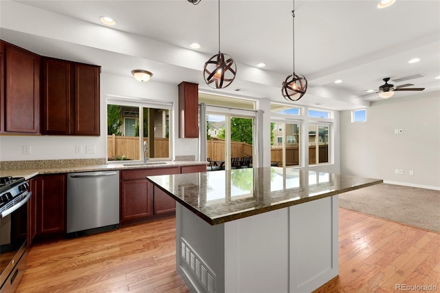 3692 Celestial Ave, Castle Rock, CO 80109 - kitchen with appliances with stainless steel finishes, a sink, recessed lighting, dark stone countertops, and light wood-style floors