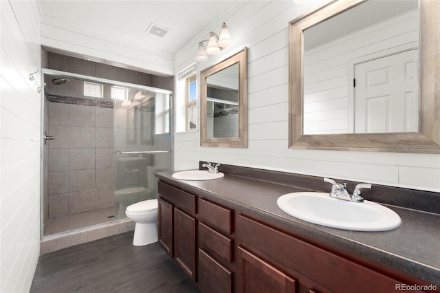3692 Celestial Ave, Castle Rock, CO 80109 - bathroom with toilet, a stall shower, double vanity, and wood finished floors