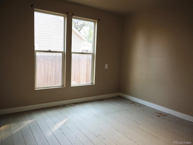 empty room with light hardwood / wood-style flooring