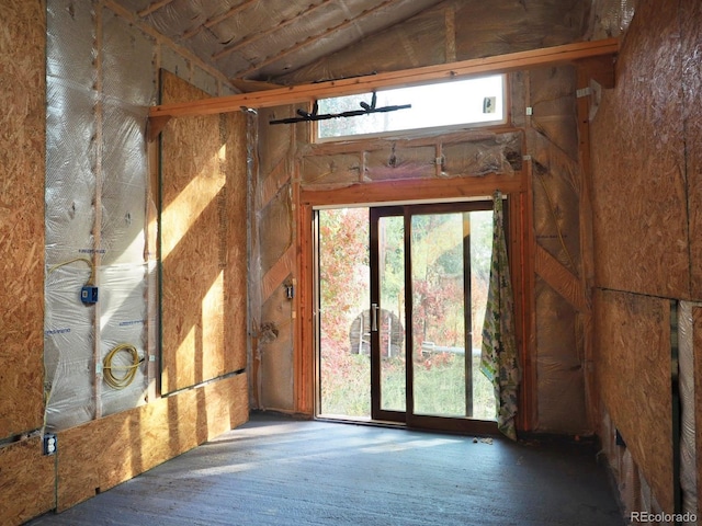 unfurnished room featuring vaulted ceiling