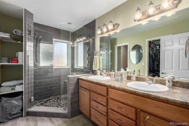 bathroom featuring vanity, hardwood / wood-style flooring, and a shower with door