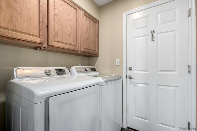 laundry room with cabinets and washer and dryer