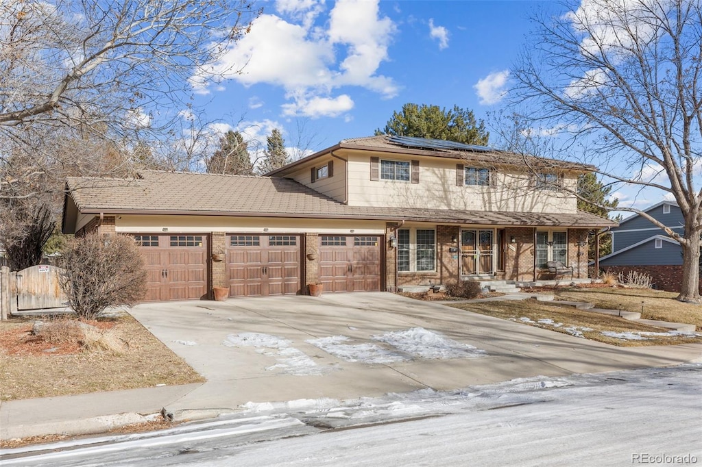 view of front property featuring solar panels, a porch, and a garage