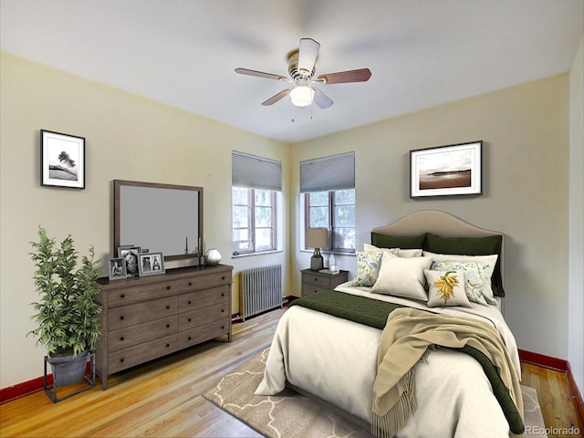 bedroom featuring radiator heating unit, wood finished floors, and baseboards