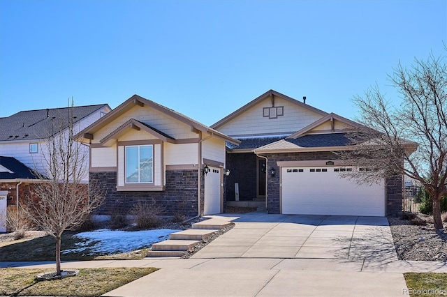 view of front of home featuring stone siding, concrete driveway, and an attached garage