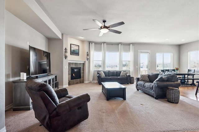 living area featuring ceiling fan, carpet, baseboards, recessed lighting, and a fireplace