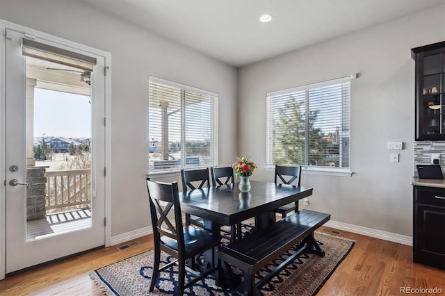 dining room with recessed lighting, baseboards, and light wood-style floors