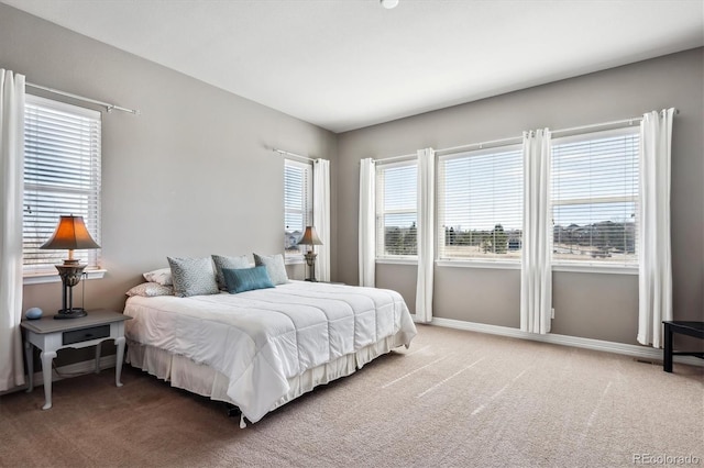 bedroom featuring baseboards and light carpet