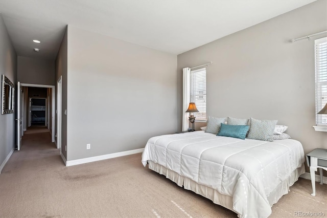 bedroom featuring light carpet and baseboards