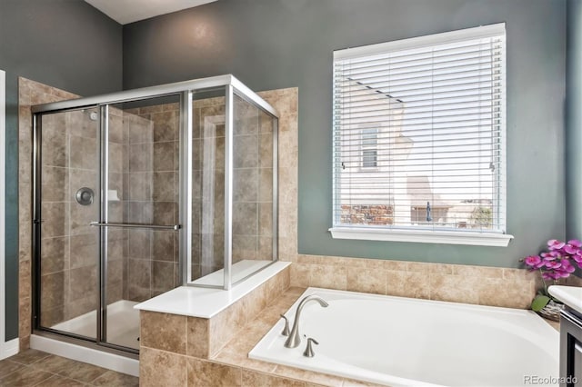 full bath featuring tile patterned flooring, a shower stall, and a garden tub