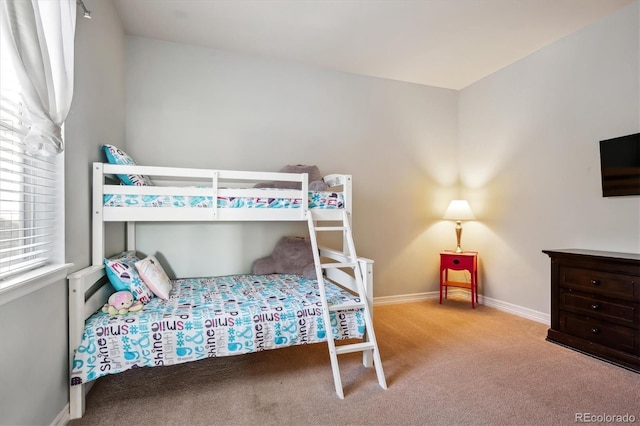 bedroom with baseboards and carpet floors