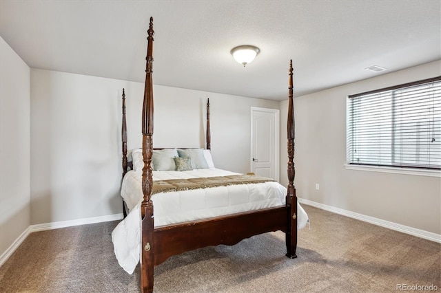 bedroom featuring visible vents, carpet, baseboards, and a textured ceiling