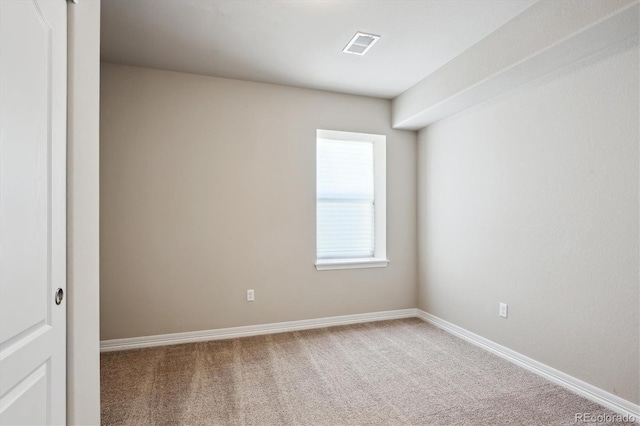 empty room with visible vents, baseboards, and carpet floors