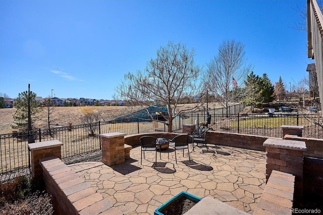 view of patio with a fire pit and a fenced backyard