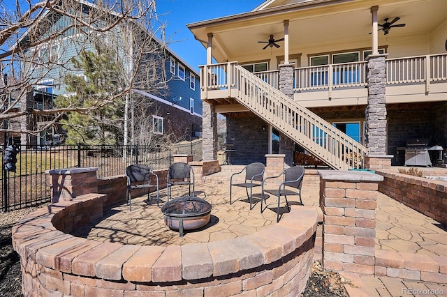 view of patio / terrace featuring a ceiling fan, fence, stairway, grilling area, and a fire pit