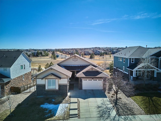 view of front of home featuring a garage, a residential view, and driveway