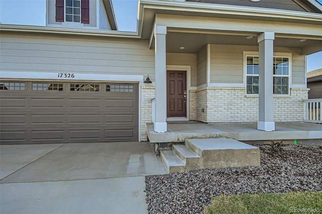 entrance to property with a garage and a porch