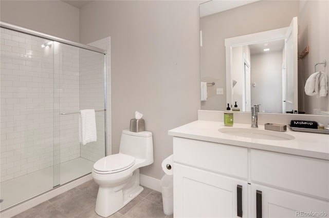 bathroom with toilet, vanity, tile patterned floors, and a shower with door