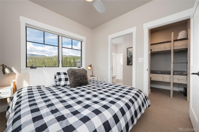 carpeted bedroom featuring connected bathroom and ceiling fan