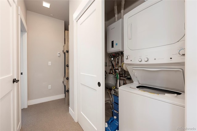 washroom featuring light colored carpet and stacked washing maching and dryer