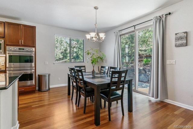 25402 E Glasgow Pl, Aurora, CO 80016 - dining room featuring wood finished floors and a chandelier