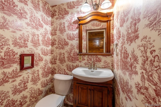 7431 Webster St, Arvada, CO 80003 - bathroom with wallpapered walls, toilet, and vanity