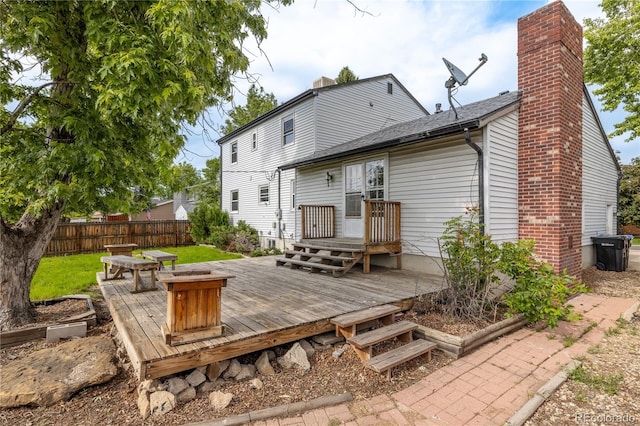 7431 Webster St, Arvada, CO 80003 - back of property with a wooden deck and a chimney