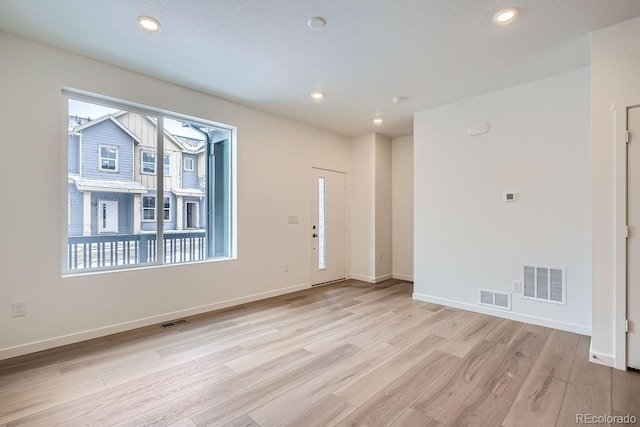 spare room with light hardwood / wood-style floors