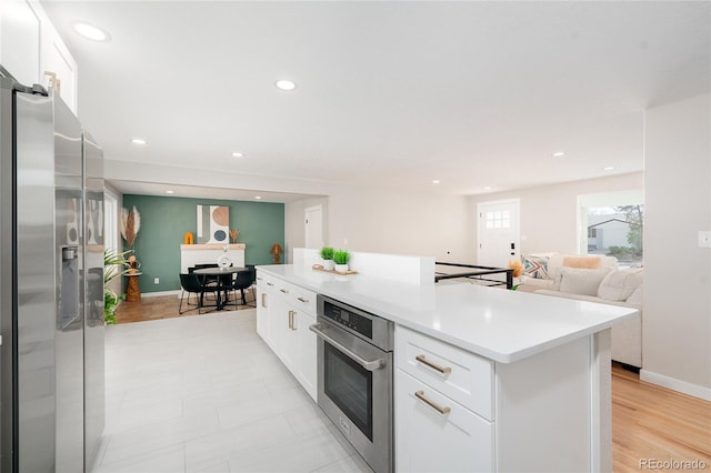 kitchen featuring white cabinetry, appliances with stainless steel finishes, and a center island