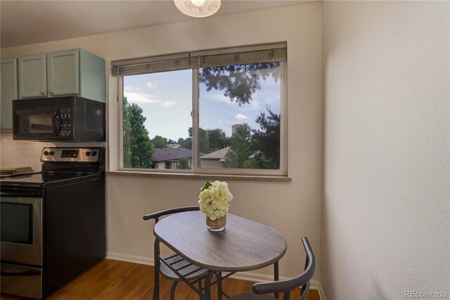 21 N Washington St Unit 301, Denver, CO 80203 - dining area featuring baseboards and wood finished floors
