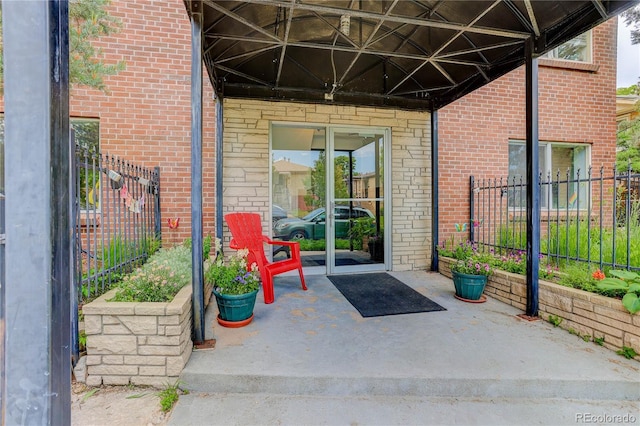 21 N Washington St Unit 301, Denver, CO 80203 - view of exterior entry featuring brick siding and a patio