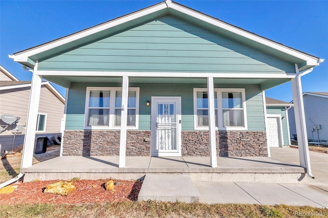 view of front of house featuring a porch and a garage