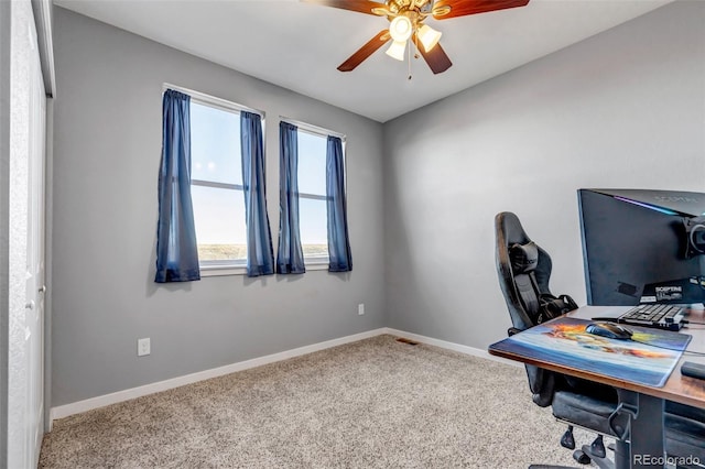 carpeted office space featuring ceiling fan