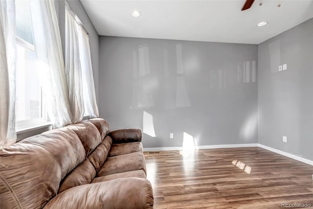 living room featuring ceiling fan and hardwood / wood-style floors