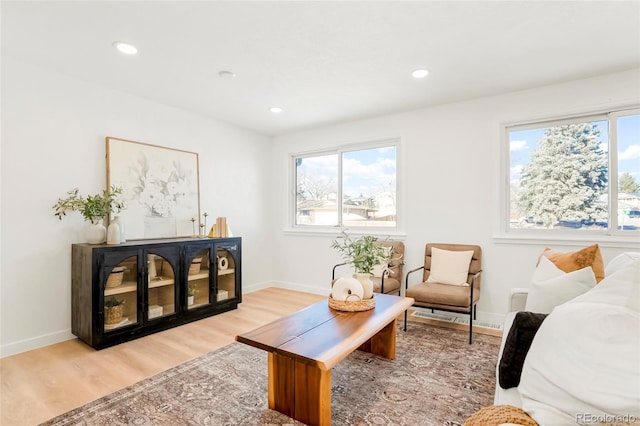 living area with recessed lighting, baseboards, and wood finished floors