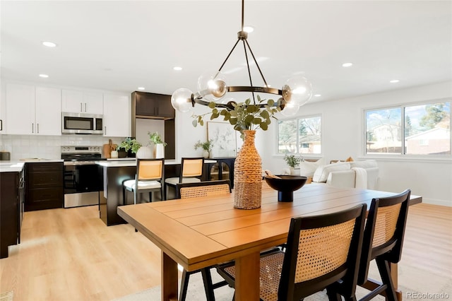 dining area featuring light wood-style floors, recessed lighting, and baseboards