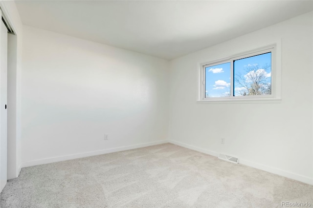 unfurnished bedroom with carpet floors, a closet, visible vents, and baseboards